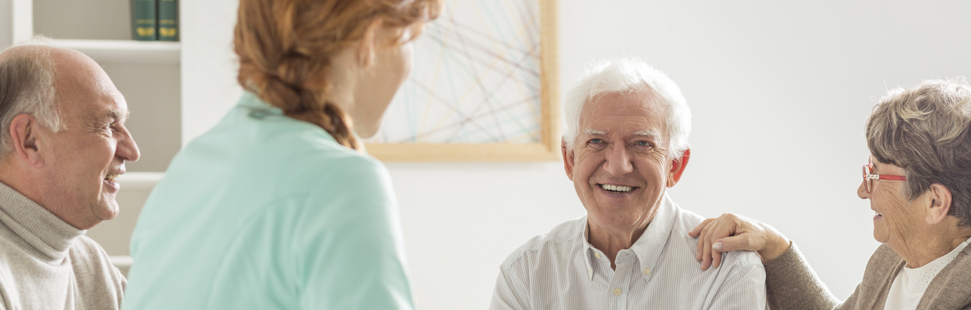 Caregiver visiting with elderly clients at home